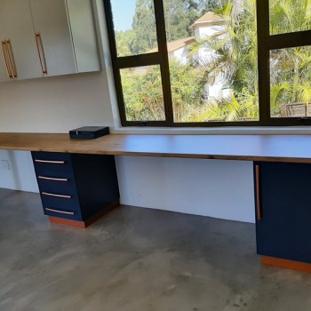 Custom built-in office desk and storage. Royal blue melamine with oak formica top